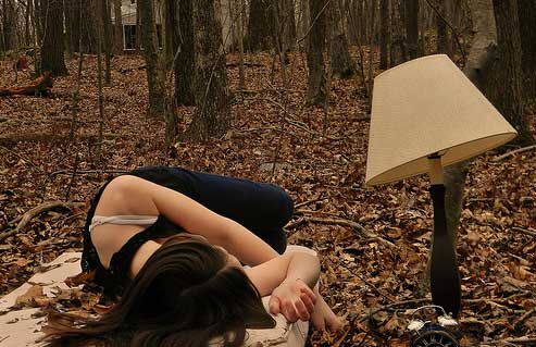 Girl laying down in woods